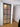 Modern hinged frosted glass door with black metal frame and wooden floor in minimal interior