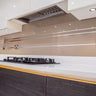 Modern kitchen with sleek glass backsplash and integrated lighting for luxury residential design
