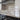 Modern kitchen with frosted glass backsplash featuring horizontal stripes, sleek black countertop and stainless steel hood