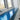 Blue sparkle glass kitchen splashback under window next to stainless steel sink and chrome faucet