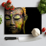 Chopping board with colorful Buddha face print surrounded by fresh tomatoes, garlic, basil, and knife