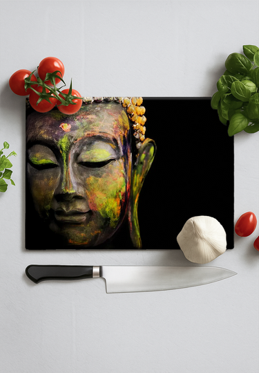 Chopping board with colorful Buddha face print surrounded by fresh tomatoes, garlic, basil, and knife