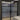 Double hinged black framed glass doors with frosted middle panels in modern interior