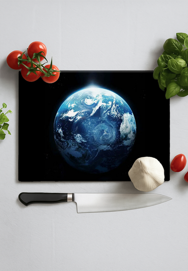 Kitchen knife and vegetables on Earth print chopping board with tomato, garlic, and herbs