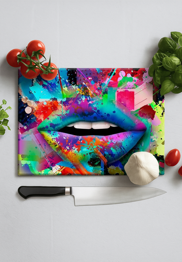 Colorful graffiti-style lips on a chopping board with knife, tomatoes, garlic, and herbs nearby