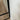 black metal frame door with glass panel next to white wall on wooden floor