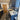Modern kitchen with blue cabinets, marble countertops, gas stove, wood floor, and decorative rugs