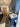 Modern kitchen with blue cabinets, marble countertops, gas stove, wood floor, and decorative rugs