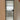 Frosted glass interior door with black metal frame and modern black handle in minimalist white hallway