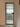 Frosted glass interior door with black metal frame and modern black handle in minimalist white hallway