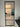 Modern black-framed glass interior door with marble floor and staircase visible
