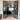 Modern double black metal frame glass doors with side panels opening to a living room with grey carpet and furniture