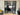 Modern double black metal frame glass doors with two side panels separating living rooms