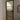 Modern interior door with black frame and frosted glass panes in a room with white walls and wooden floor