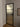 Modern interior door with black frame and frosted glass panes in a room with white walls and wooden floor