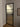 Modern interior door with black frame and frosted glass panes in a room with white walls and wooden floor