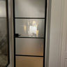 Black metal framed frosted glass interior door with home office seen through glass