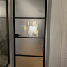 Black metal framed frosted glass interior door with home office seen through glass