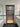 Modern bathroom with frosted glass door, black metal frame, white tiles, blue mosaic accent, bathtub, and sink cabinet