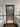 Modern bathroom with frosted glass door, black metal frame, white tiles, blue mosaic accent, bathtub, and sink cabinet