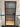 Modern bathroom door with frosted glass panels and black frame against white tiled walls