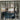 Modern black metal double glass doors with side panels separating living and sitting areas