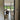Open black-framed glass door leading to living room with brown armchair and dog by large sliding garden doors