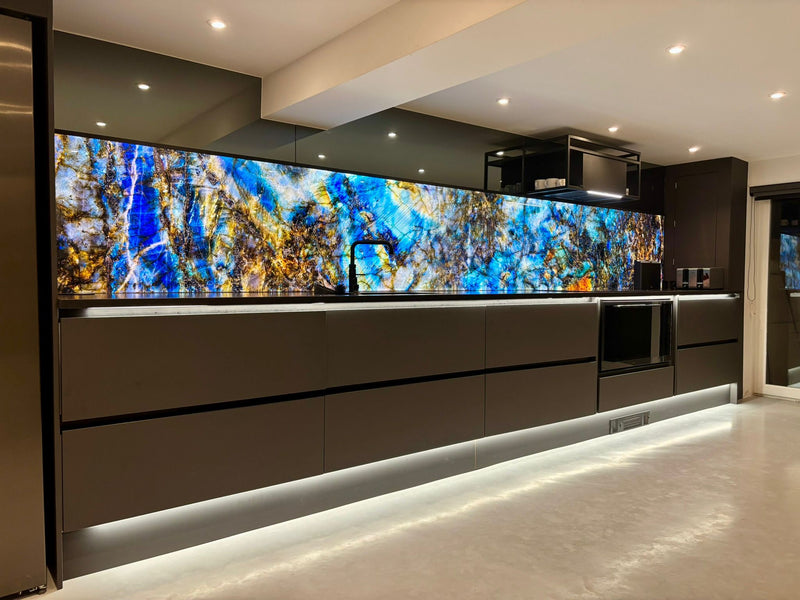 Bespoke LED backlit glass kitchen splashback with vibrant blue and gold abstract art, modern luxury interior