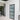 Interior with modern hinged black metal framed frosted glass door and adjacent clear glass double doors