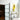 Modern frosted glass hinged door with black frame in bright room featuring abstract yellow painting and decorative table