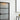 Modern interior with frosted glass hinged door framed in black metal, white walls, and abstract yellow art
