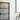 Modern interior with frosted glass hinged door framed in black metal, white walls, and abstract yellow art