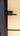 Modern black metal hinged door handle on frosted glass panel door with blue frame