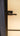 Modern black metal hinged door handle on frosted glass panel door with blue frame