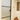 Frosted glass hinged door with black frame in a white wall hallway, stained glass panels, shoes on floor