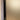 Close-up of a frosted glass hinged door with black metal frame inside a beige wall frame