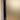 Close-up of a frosted glass hinged door with black metal frame inside a beige wall frame