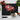 Black chopping board with red poppy print surrounded by cherry tomatoes, basil, garlic, and chef knife