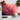 Red dandelion printed glass chopping board with knife, garlic, cherry tomatoes, and basil leaves