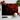 Rectangular black chopping board with red smoke design, surrounded by tomatoes, basil, garlic, and knife