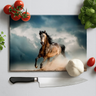Rectangular chopping board with a running horse print, surrounded by tomatoes, basil, garlic, and kitchen knife