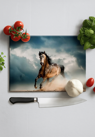 Rectangular chopping board with a running horse print, surrounded by tomatoes, basil, garlic, and kitchen knife