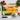 Chopping board with sunset seascape featuring small boat, tomatoes, basil, garlic, and kitchen knife