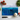 Rectangular chopping board with textured blue shades design surrounded by kitchen knife, garlic, tomatoes, and basil leaves