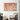Vibrant orange and blue abstract art on wall above modern houndstooth armchair in stylish living space