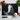 Rectangular chopping board with white horse painting surrounded by cherry tomatoes, basil, garlic, and kitchen knife