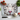 Cutting board with a close-up white tiger face print surrounded by vegetables and knife