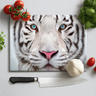 Cutting board with a close-up white tiger face print surrounded by vegetables and knife