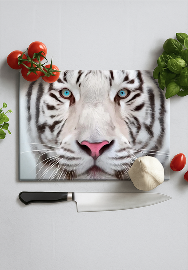 Cutting board with a close-up white tiger face print surrounded by vegetables and knife