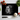 Black chopping board with white tiger face in spotlight surrounded by garlic, cherry tomatoes, basil, and kitchen knife